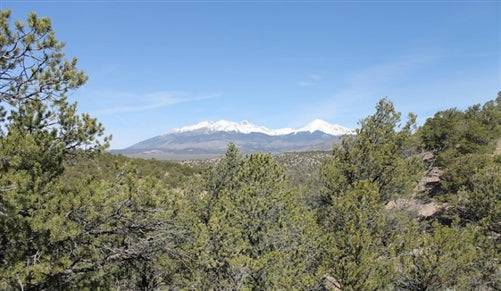 Aerial view of 5.14-acre land parcel in Sangre De Cristo Ranches, Costilla County, Colorado with open grassy fields and scenic landscape.