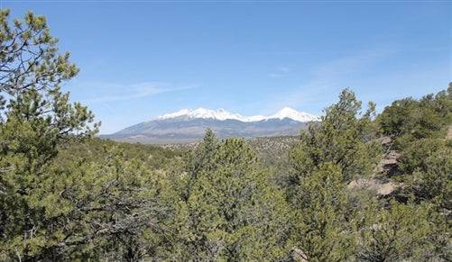 Aerial view of 5.02-acre Sangre De Cristo Ranches land in Costilla County, Colorado, with scenic mountain backdrop and open grassy terrain.