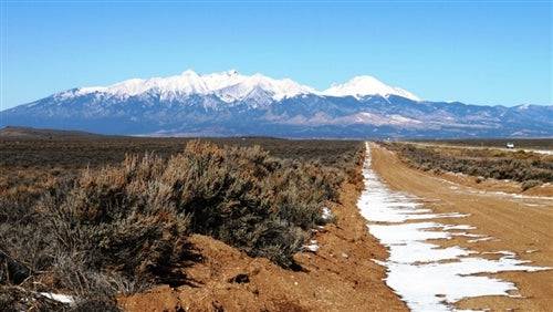 Aerial view of Colorado San Luis Valley ranch lot 1, unit 01, block 15, in Costilla County, with nearby natural landscape.