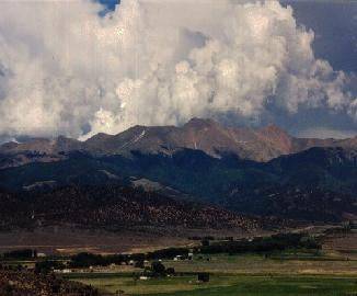 Aerial view of 10-acre Colorado San Luis Valley estate in Costilla County, featuring open land with mountain backdrop, by Onlinelandsales.
