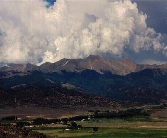 Aerial view of two 5+ acre land lots in San Luis Estates South, Colorado, showing open terrain and surrounding natural landscape.