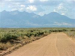 A scenic view of a 5-acre parcel in Costilla County, San Luis Valley, Colorado, with open land and mountain backdrop.