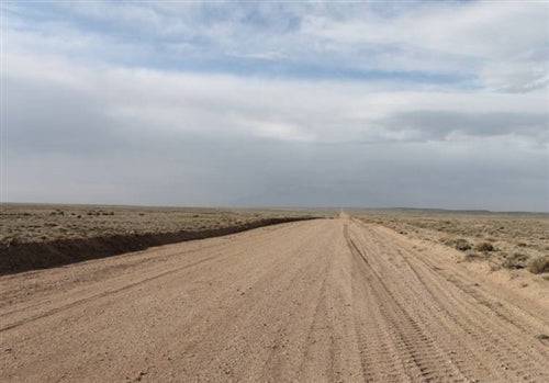 Aerial view of a 5-acre Colorado property in Costilla County, San Luis Valley with open land and mountain scenery.