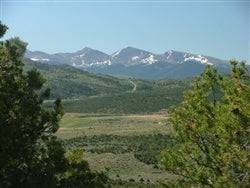 Aerial view of Eagle Ridge Ranch in Costilla County, Colorado, featuring scenic 40-acre land with open meadows and mountain backdrop.