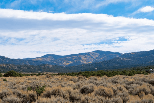 Aerial view of Colorado Trinchera Creek Estates Lot 6 in Costilla County, showing surrounding land and natural creek area.