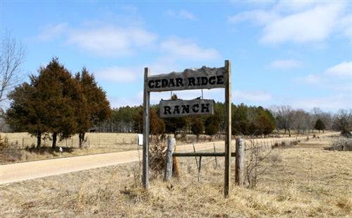 Aerial view of Cedar Ridge Ranch in Phelps County, Missouri, featuring 3.72 acres with creek on OnlineLandSales property listing.