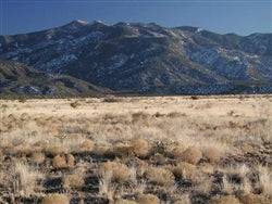 Aerial view of a .25 acre land parcel in Rio Del Oro, Valencia County, New Mexico, showing open desert terrain and surrounding landscape.