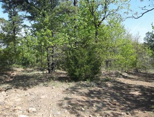 Aerial view of Pine Mountain Ranch in Latimer County, Oklahoma, showing wooded 6.65-acre property with natural landscape.