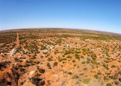 Aerial view of Texas Knox County Red Rock Ranch, a 19.26-acre rural property with red rock terrain and open land.
